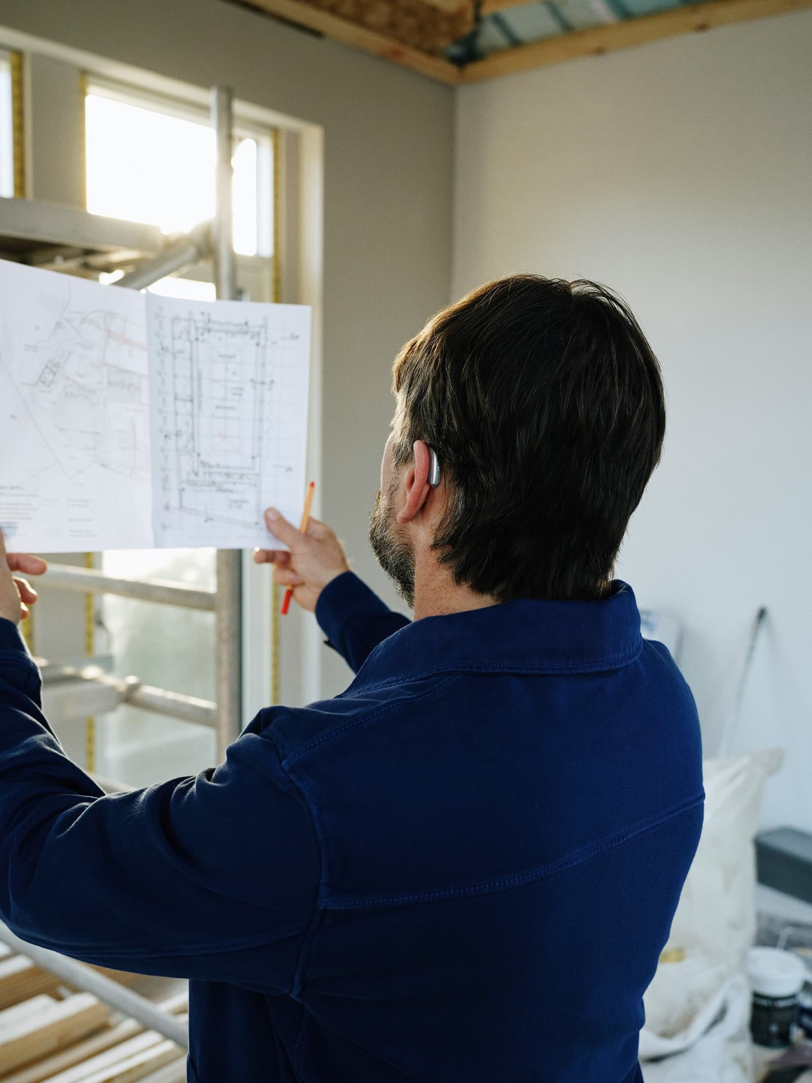 Contractor reviewing blueprints on an active construction project